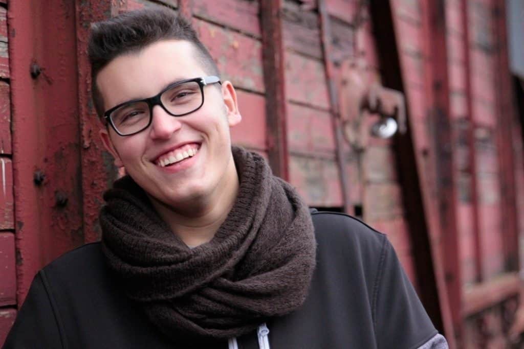 Boy Laughing Against A Blurred Background