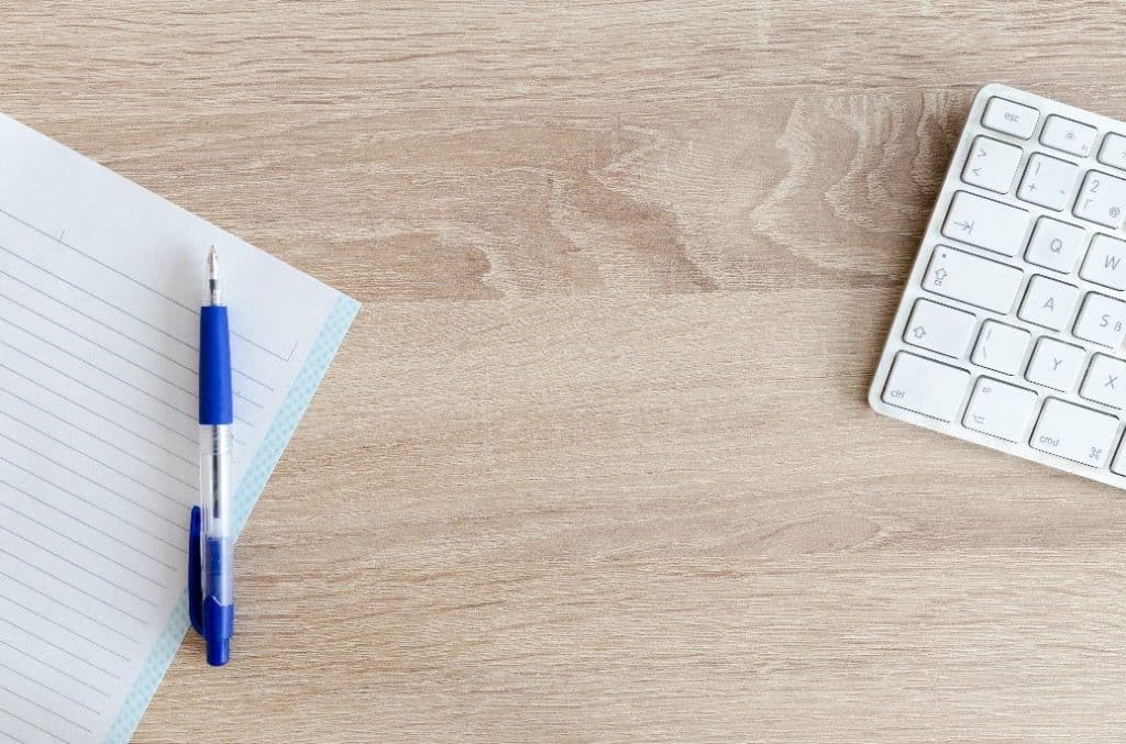 Keyboard Along With Pen And Paper